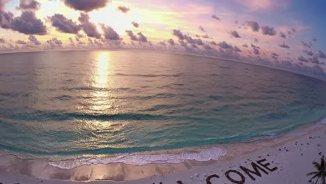 welcome to paradise - aerial view of a tropical beach at sunset