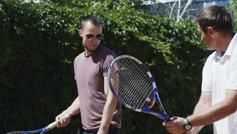 two men playing tennis