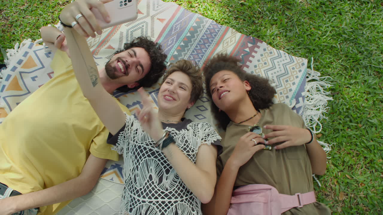 Joyous Friends Taking Selfie on Green Grass in Park