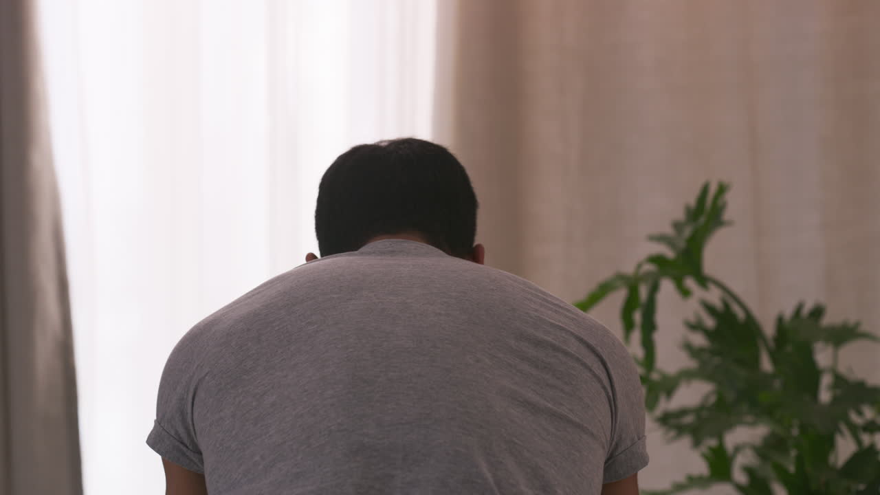 Man in gray t-shirt indoors