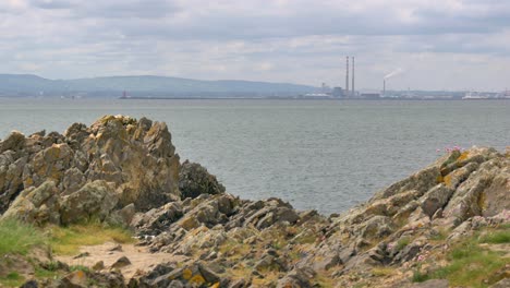 Dublin-Poolbeg-chimneys-in-distance-across-irish-sea-Howth-Ireland