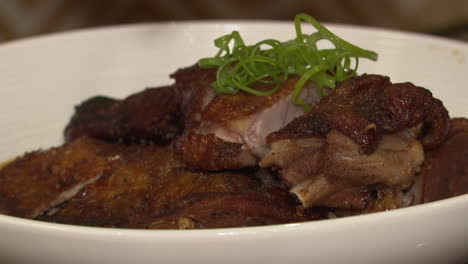 roasted duck dish with chopsticks