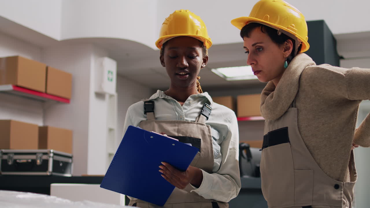 Warehouse workers inspecting a package in a storage facility