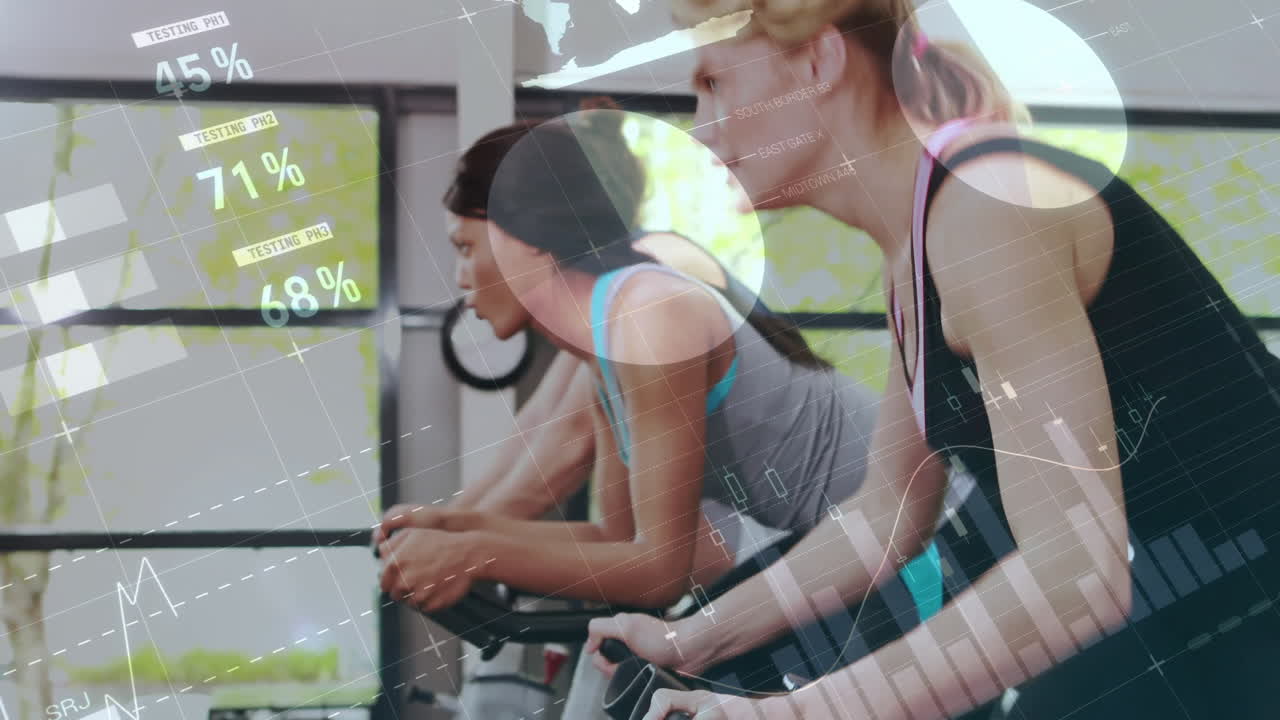 Friends cycling in fitness studio, displaying animated performance metrics and schematic graphics