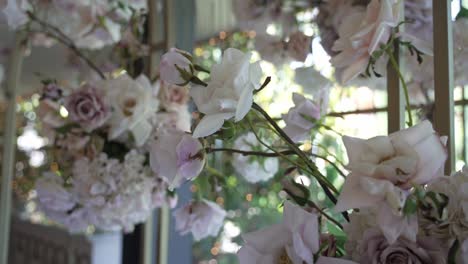 soft focus close up of blush pink and white floral wedding decor with lush greenery