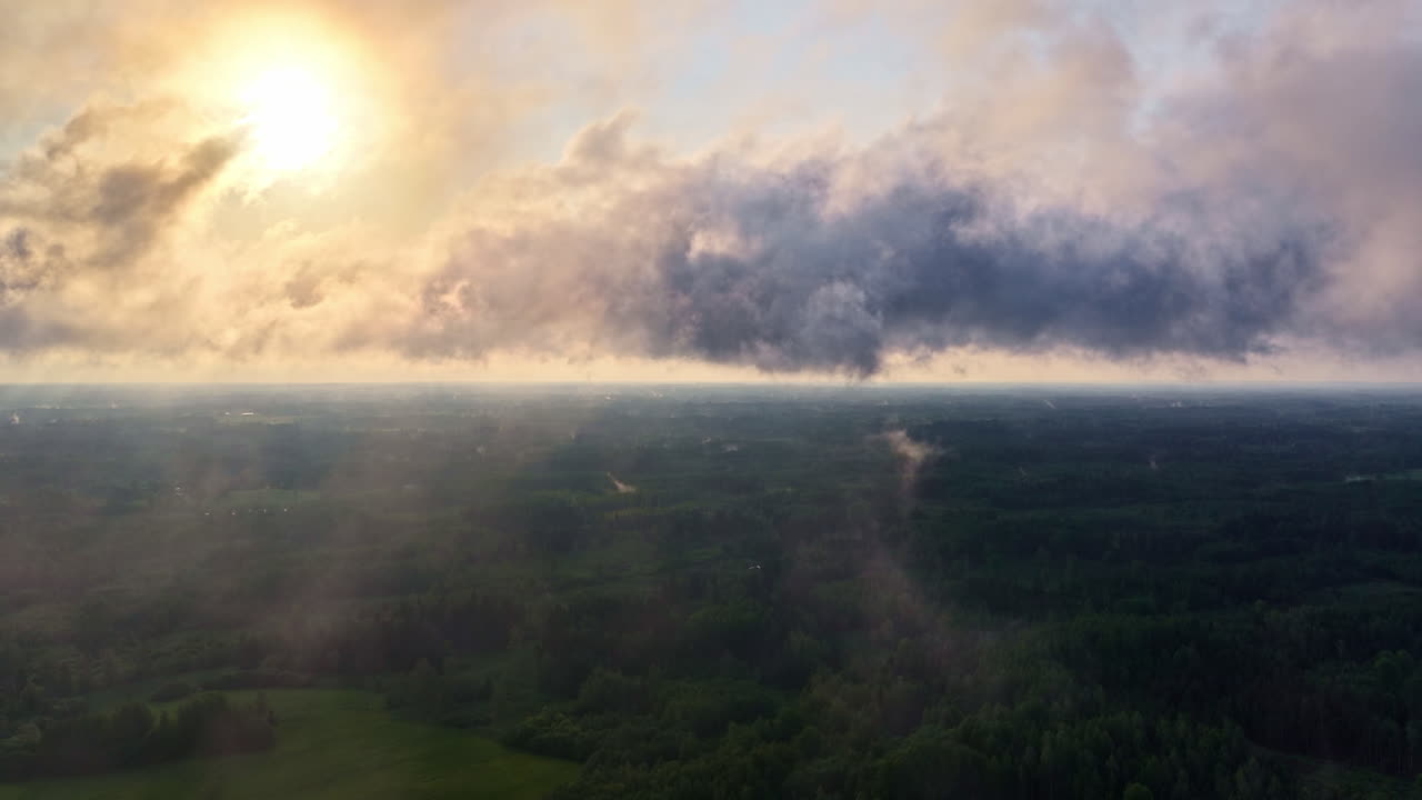 Hazy sunshine through cloudscape and Latvia, aerial view