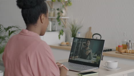 woman having a video call with a man in a kitchen