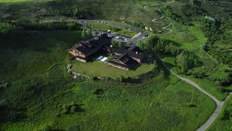 revealing drone shot of the cochrane ranchehouse in summer time