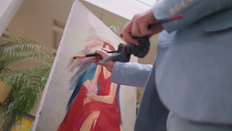 artist painting a portrait in a studio