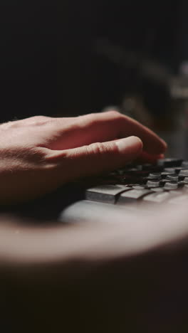 el músico procesa la pista de audio en primer plano en el estudio. las manos del hombre escriben en el teclado de la computadora escuchando un nuevo disco en el lugar de trabajo. tecnología musical digital