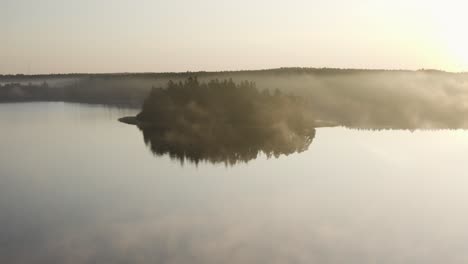 Aerial-of-Misty-Morning-above-Scandinavian-Lake-with-Forest-in-Background