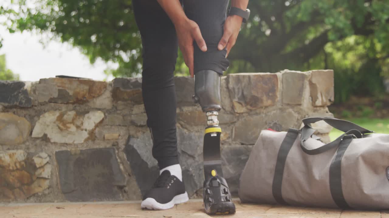 Front view man readjusting his prosthetic leg