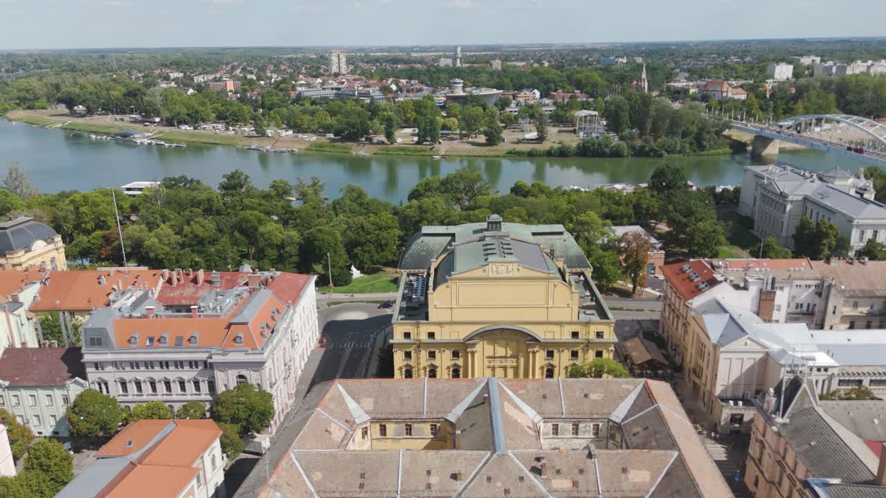 Aerial of the National Theatre of Szeged, showcasing its architecture with the Tisza River flowing nearby