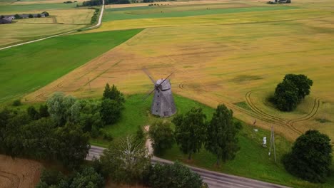 aerial shot of an old windmill in the field, parallax shot