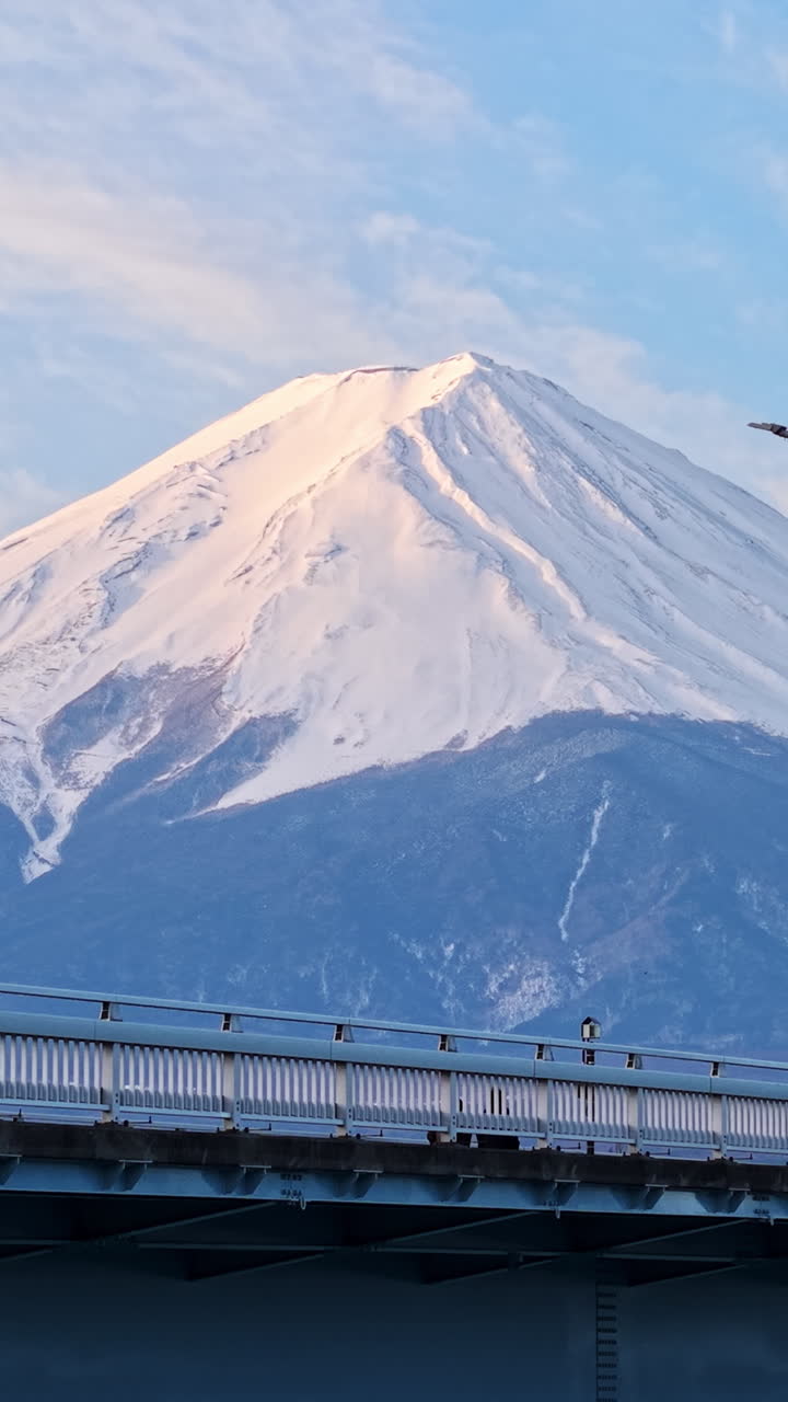 Aerial drone view of the Kawaguchiko-Ohashi bridge near the Fujikawaguchiko town in Japan with Mount Fuji on the background
