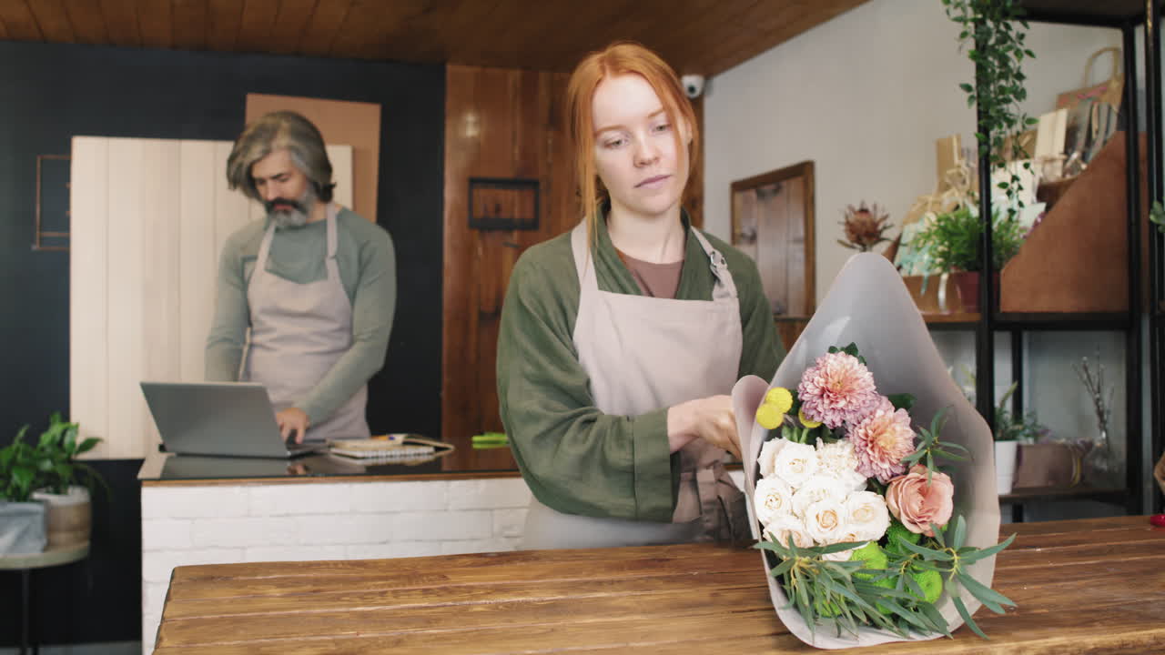 Young Woman Working At Flower Shop