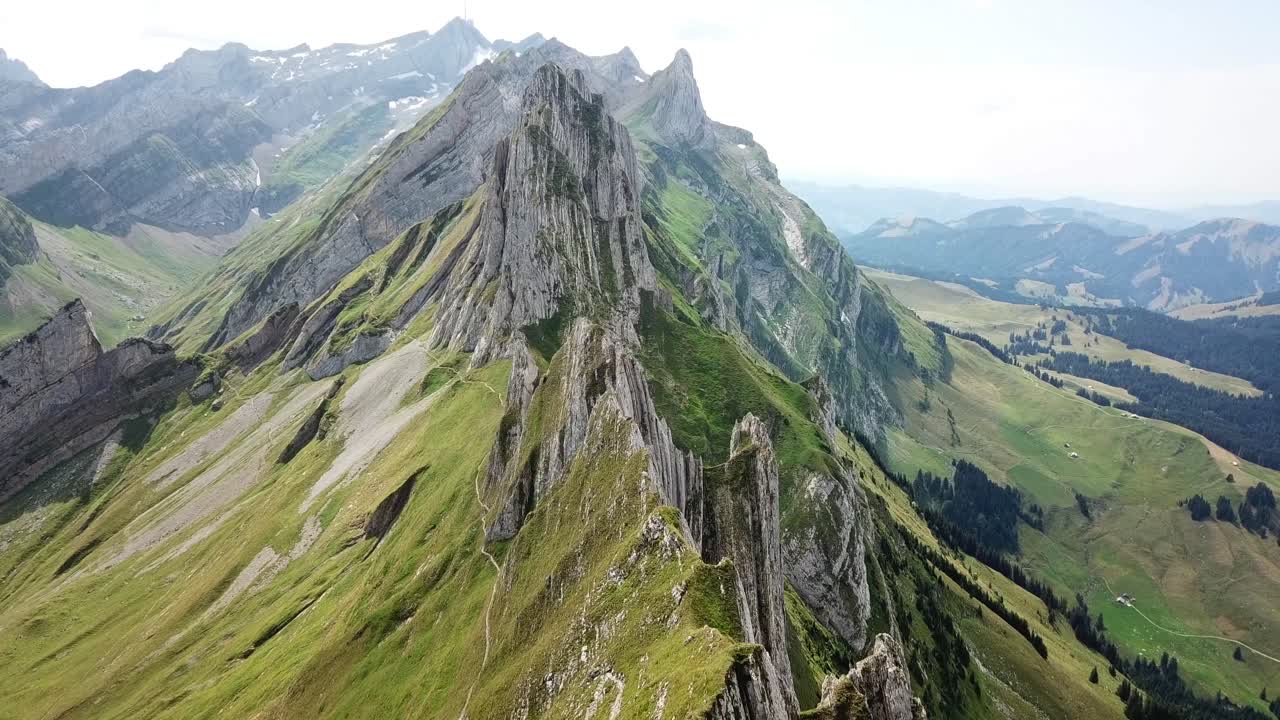 Drone slow motion shot revealing Schafler ridge hiking trail in Switzerland, its breathtaking views of the swiss alps and a challenging adventure for hikers seeking stunning landscapes.