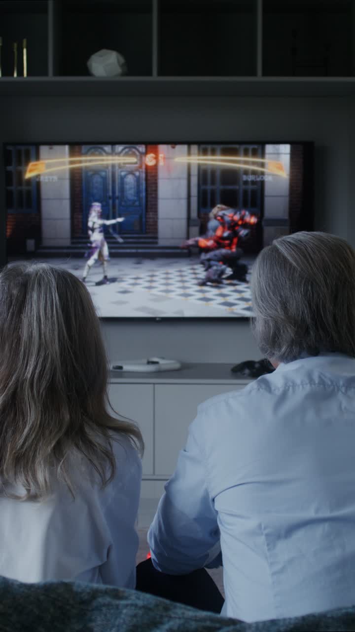 Couple Watching Fighting Game on TV