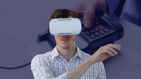 Animation-of-caucasian-man-wearing-vr-headset-over-payment-terminal-in-background