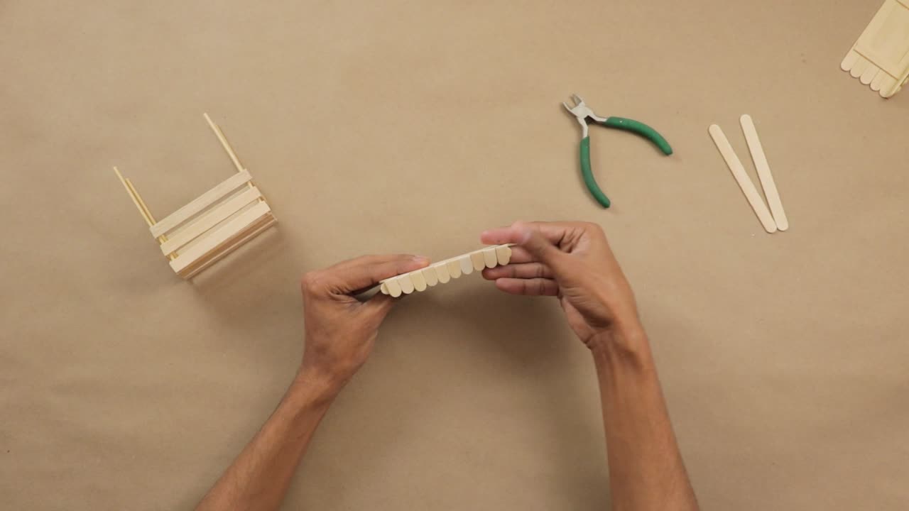 Making creative handmade crafts from popsicle sticks with pliers