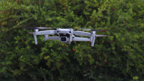 close-up of drone quadcopter with digital camera flying in air moving side to side, futuristic device that captures aerial photography and land survey