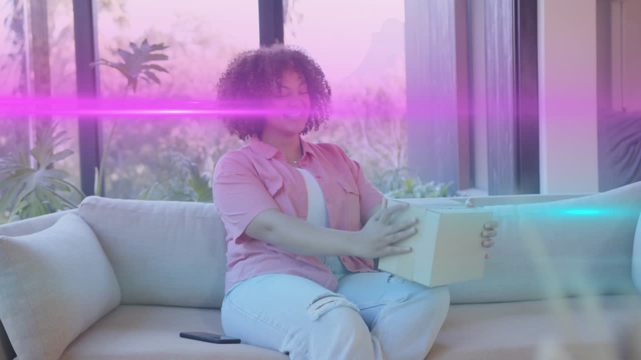 Woman reaching for parcel after light streak, tapping smartphone and inspecting delivery contents