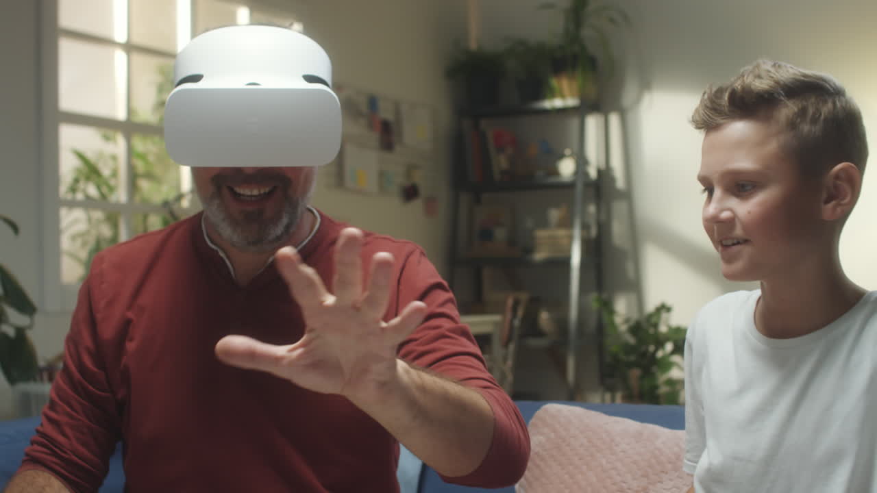 Father and Son Experiencing Virtual Reality Together at Home
