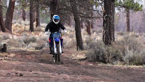 Motorcycle-dirt-bike-rider-in-slow-motion-through-whoops