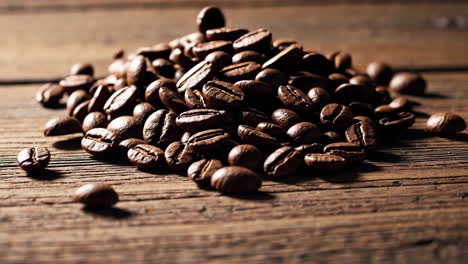 coffee beans falling on wooden table