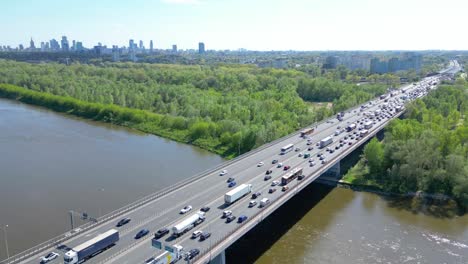 Aerial-view-of-traffic-moving-on-a-massive-bridge-over-the-Vistula-River-in-Warsaw