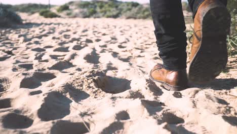zapatos de hombre caminando por la arena tiro de seguimiento detallado