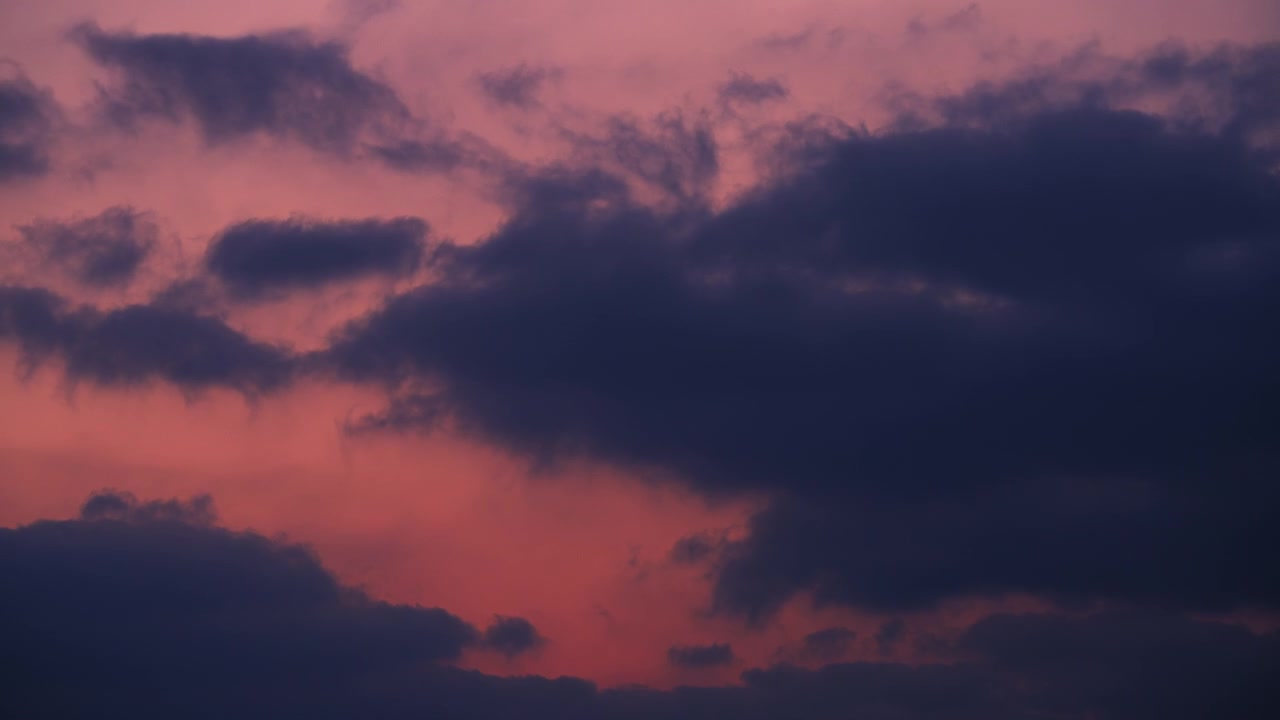 Epic stormy clouds moving fast at sunset