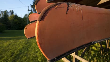 Old-Vintage-Canoes-At-A-Backcountry-Recreational-Outfitters-In-South-Algonquin,-Canada