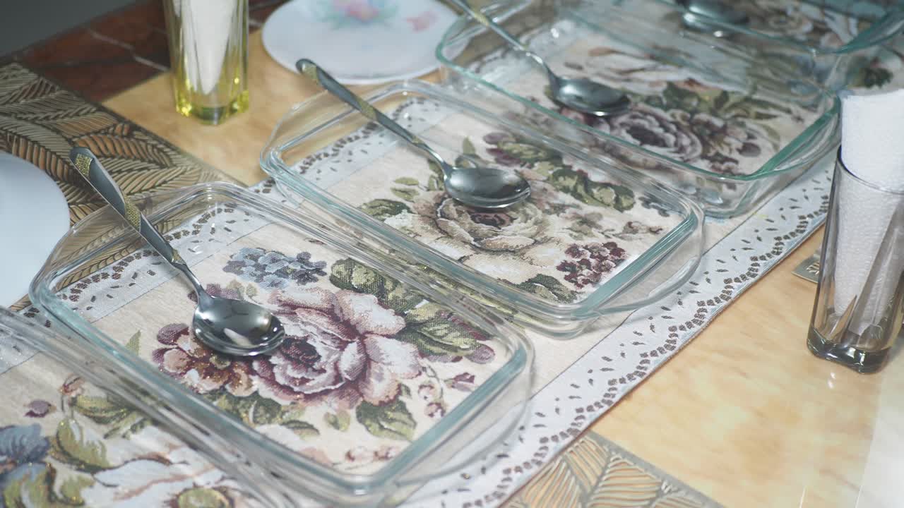 Empty Glass Baking Dishes and Spoons on a Table