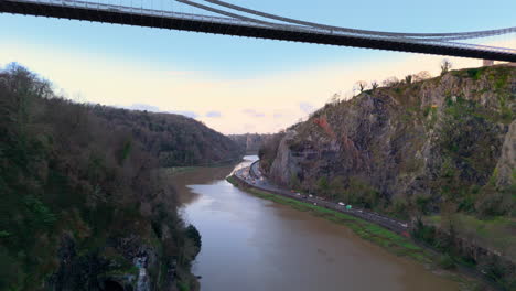 Backwards-aerial-dolly-reveals-historic-Clifton-suspension-toll-bridge,-Hotwells