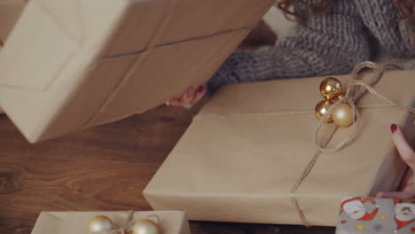gift box new year day celebration. young attractive woman with gift box near fireplace