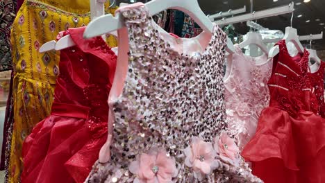 collection of children's party dresses on display