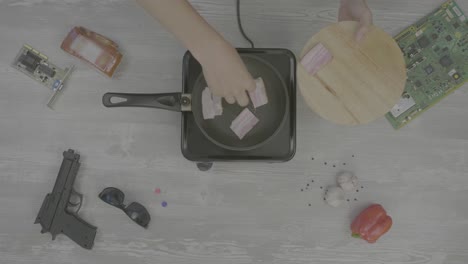 cooking bacon with various items on the table