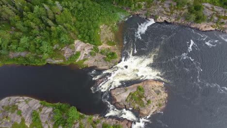 aerial-descending-on-wild-rapids-from-a-northern-stream-where-an-eddy-forms-after-the-rapids
