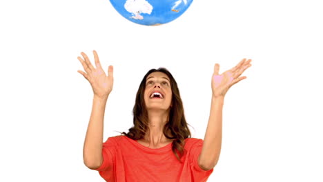 Woman-throwing-a-globe-on-white-background