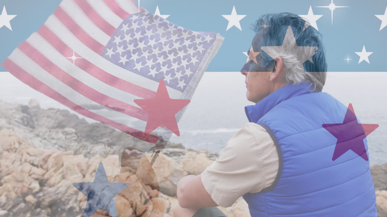 미국  ⁇ 발의 애니메이션 고위 백인 남자가 산의 바위에 앉아 있습니다.