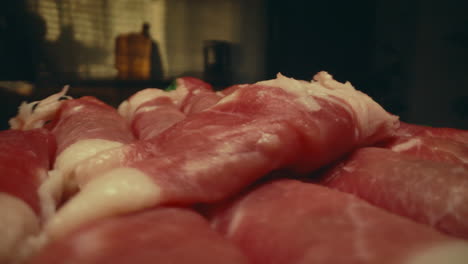 Close-up of Raw Rolled Bacon Slices