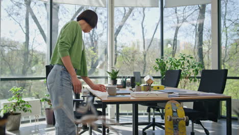 relaxed woman opening laptop starting work office. asian businesswoman working