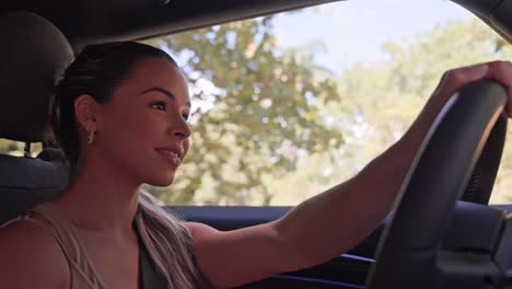 portrait of beautiful cheerful young woman driving mini cooper car