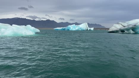 melted blue icebergs on glacial lagoon due to global warming