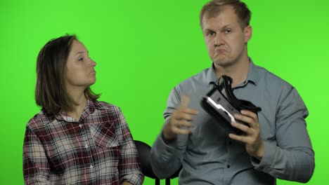 man and woman using vr headset helmet to play game. watching virtual reality 3d video. chroma key