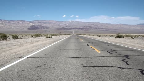 Highway-crossing-Death-Valley,-Mojave-Desert,-California,-Aerial-Dolly-left-shot