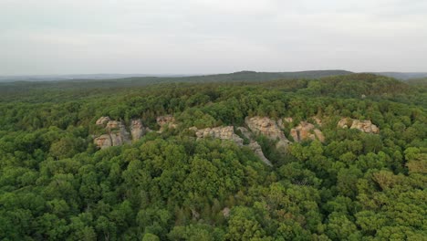 beautiful rocky landscape covered in dense forest, aerial view