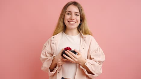young woman holding a gift expressing different positive emotions