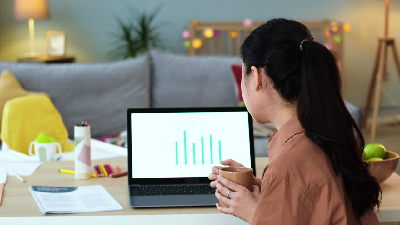 Back view of asian woman working on laptop